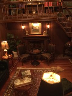 a living room filled with furniture and a fire place in the middle of a wooden floor