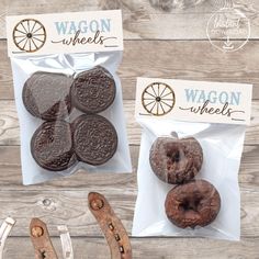 three bags of chocolate covered cookies sitting on top of a wooden table next to scissors