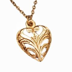 This is a sweet and elegant heart necklace.  It is small and understated, yet detailed and ornate.  A beautiful gift to someone you love.  Gold chain is 18 inches long. Antique Heart-shaped 14k Gold Necklace, Dainty Heart Pendant Jewelry With Vintage Charm, Antique Gold Heart Necklace For Anniversary, Vintage Heart Necklace For Mother's Day, Vintage Engraved Heart Necklace For Mother's Day, Vintage Style Engraved Heart Necklace For Mother's Day, Vintage Charm Heart Pendant Jewelry Gift, Vintage Yellow Gold Heart Charm Necklace, Vintage Gold Heart Necklace In Brass