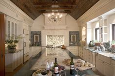 a kitchen filled with lots of counter top space and bottles of wine on the counter