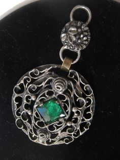 "Metal scrolls, wire work brooch / pendant piece with beautiful emerald green stone that can be used to make other jewelry 3\" tall/long x 1 3/4\"wide, 1/2\" deep Vintage" Green Metal Jewelry With Large Pendant, Handmade Green Brooches For Formal Occasions, Green Ornate Jewelry, Handmade Green Brooch For Formal Occasions, Green Pendant Brooch For Gift, Vintage Green Wire Wrapped Jewelry, Ornate Green Pierced Jewelry, Green Large Pendant Metal Jewelry, Victorian Green Metal Jewelry