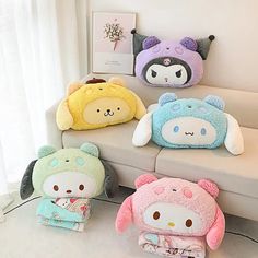 four stuffed animals sitting on top of a couch