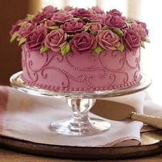 there is a pink cake with flowers on it