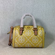 Brand New Never Been Carried. Golden Sunset T Monogram Embossed Mini Barrel Bag By Tory Burch. Note: This Embossed Leather May Seem Stiff When It Is New. It Will Soften With Use. Please Feel Free To Ask For More Photos! This Bag Is Made Of Soft Yellow Embossed Leather Dimensions: 7.4” Wide X 4.8” Tall Center X 4.5" Deep. Handle 3" Drop Long Leather Strap Is Adjustable And Detachable Strap And Handle Are In Tan Leather Zipper Closure Interior: Single Compartment With 1 Card Pocket Microsuede Lini Designer Yellow Shoulder Bag With Detachable Handle, Designer Yellow Top Handle Shoulder Bag, Designer Yellow Shoulder Bag With Detachable Strap, Tt Logo, T Monogram, Golden Sunset, Barrel Bag, Soft Yellow, Tory Burch Bag