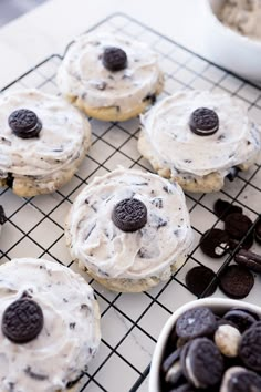 cookies and oreo cookies on a cooling rack with white frosting in the middle