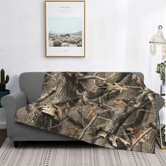 a living room with a couch covered in a camo blanket