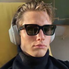 a young man wearing sunglasses and headphones