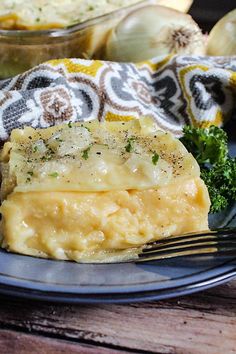 a piece of food on a plate with a fork and some broccoli next to it