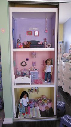 a doll house with dolls and furniture in it