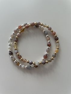 This Botswana Agate bracelet is the perfect neutral addition to any bracelet stack! Botswana Agate is a variety of chalcedony, known for its mesmerizing patterns and unique coloration of brown, grey, pink, orange and purple. Each bead in this bracelet showcases the stone's characteristic banding, creating a distinct and eye-catching look. The 4mm size of the beads strikes a perfect balance between delicacy and presence, making it suitable for everyday wear or special occasions. The bracelet is e Botswana Agate Bracelet, Everyday Beaded Agate Bracelets, Everyday Agate Beaded Bracelets, Everyday Agate Hand-strung Bracelets, Everyday Agate Beaded Bracelet, Everyday Hand-strung Agate Beaded Bracelets, Everyday Hand-strung Agate Bracelets, Stackable Agate Bracelets With Round Beads, Elegant Brown Agate Bracelets