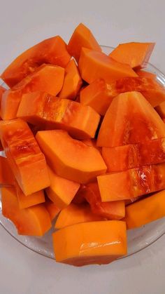 cut up pieces of orange fruit on a glass plate