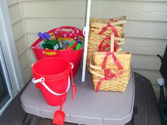 two buckets and an umbrella on a table