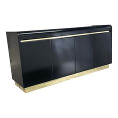 a black cabinet with gold trim and doors