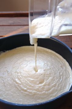 the batter is being poured into the pan