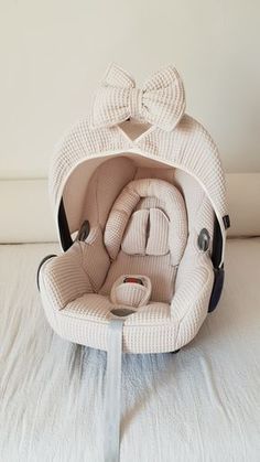 an infant car seat with a bow on it