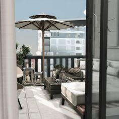 an open balcony with furniture and an umbrella