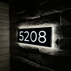 a black and white photo of a wall with the number 2098 illuminated on it