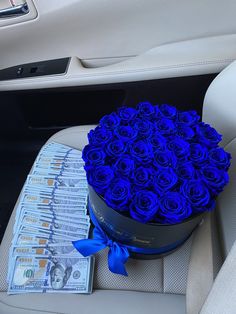 a bouquet of blue roses sitting on top of a car seat