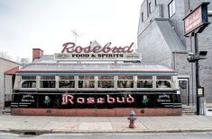 an old bus is parked in front of a restaurant on the side of the road