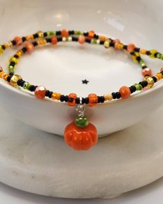 Cute and festive fall necklace measures 16.5 inches long with a spring ring closure. The little orange pumpkin bead measures 11 mm and is complemented by an assortment of orange, black, green and yellow seed beads. All fittings are sterling silver. Your order will ship within 1-2 business days of ordering and will arrive sturdily packaged in a ready to gift box. Item ships from Arizona. To see more items from the Halloween/ fall collection, click here: https://www.etsy.com/shop/TheDreamingMushro Fairy Punk, Fall Necklace, Punk Necklace, Pumpkin Bead, Autumn Necklace, Halloween Necklace, Gilbert Az, Orange Pumpkin, Halloween Fall