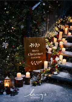 christmas decorations and candles are on the steps in front of a tree with merry christmas everyone written on it