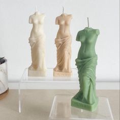 there are three candles that look like statues