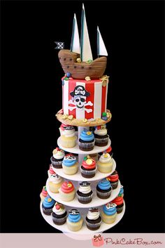 cupcakes are stacked up in the shape of a pirate ship