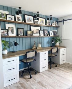 a home office with two desks and pictures on the wall above it, along with several framed photos