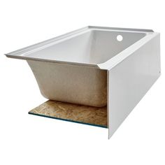 a white sink sitting on top of a wooden counter next to a brown tile floor