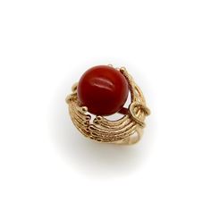 This is part of Chairish’s Fine Jewelry assortment.  At Kirsten’s Corner we love vintage coral, and this ring centers around a 12mm round sphere of well-saturated deep red Sardinian coral. The ball is centered in a tentacle-like circular mount that flows from its base and grasps the coral ball in a beautiful sci-fi fashion.  The 14k gold tentacles have a textured matte surface, ending in tiny golden balls that come together on either side of the sphere like finger tips on a hand. Circa the 1970’s, this is a great conversation piece that is both unique and elegant.   The ring is marked as 14k. It weighs 7.41 grams. The circular element measures 3/4” and the ring rises up 1/2” high on the finger. Made in Italy.   Ring size 5. Elegant Coral Ring Jewelry, Elegant Red Dome Ring For Formal Occasions, Elegant Red Dome Ring For Anniversary, Elegant 14k Gold Rings With Round Beads, Formal Red Dome Ring, Sphere Jewelry, Sci Fi Jewelry, Sphere Ring, Orange Cocktails