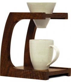 a wooden stand with two coffee cups and a cup holder on the top one is holding a white mug