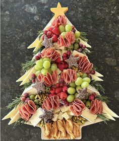 a christmas tree made out of fruits and nuts