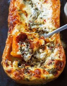 a baked dish with cheese and spinach