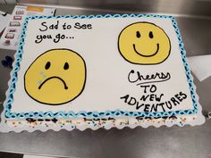 a sheet cake that has been decorated with two smiley faces and the words sorry to new adventures written on it