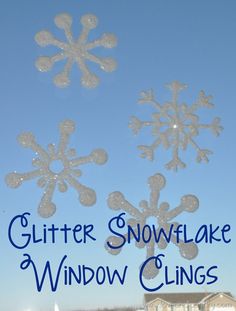 snowflake window clings in front of a blue sky with the words glitter snowflake window clings