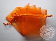 small orange bags are sitting on a white surface