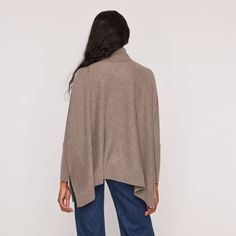 This versatile Turtleneck Poncho can be styled as a pullover or poncho, providing multiple options for a comfortable and chic look. Its one size fits all design makes it a perfect addition to any wardrobe. Made with cozy cashmere, it's sure to keep you warm and stylish during colder months. Poncho Solid Flat knit Turtleneck 25" length from shoulder 100% Cashmere 70095098A Oversized Cashmere Poncho, One Size Cashmere Poncho For Layering, Relaxed Fit Cashmere Tops For Fall, Winter Cashmere Poncho One Size, Chic Cashmere Poncho For Layering, Chic Oversized Cashmere Cape, One Size Cashmere Poncho For Fall, Fall Soft Knit Poncho, Cozy Cashmere Cape