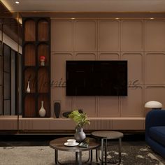 a living room with two blue couches and a television mounted on the wall above it