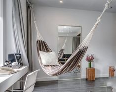 a hammock hanging from the ceiling in a bedroom