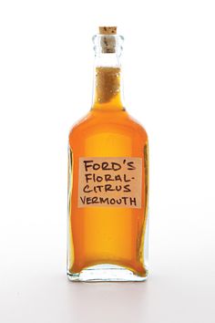 a bottle of food's floral vermouth on a white surface with the label removed