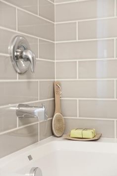 a bathroom sink with a toothbrush and soap dispenser