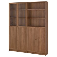 a wooden bookcase with glass doors on the top and bottom shelves, in front of a white background