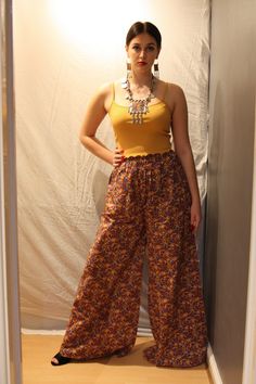 A beautiful pair of handmade kalamkari palazzo pants made from Indian cotton. Kalamkari is an art form from the Indian states of Andhra Pradesh and Telangana. The word comes from the persian "qalam" meaning pen. Traditionally this art was hand drawn directly on the fabric by artisans. The fabric used in these trousers is a machine made version.  They have an elasticated waist and will fit UK sizes 4-12. Length: 46 inches Traditional Pants With Printed Motifs For Festivals, Traditional Block Print Pants, Cotton Wide Leg Bottoms With Paisley Print, Wide Leg Cotton Bottoms With Paisley Print, Bollywood Style Straight Pants For Festivals, Bollywood Straight Pants For Festivals, Bollywood Style Cotton Bottoms For Navratri, Yellow Bohemian Cotton Pants, Traditional Yellow Cotton Bottoms