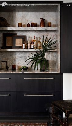 a chair sitting in front of a cabinet filled with bottles