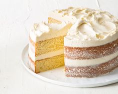 a cake with white frosting is on a plate