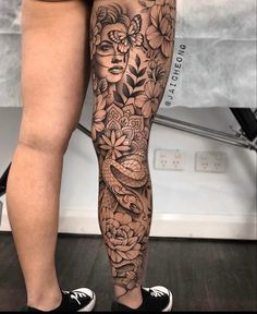 a woman's legs with flowers and birds on them