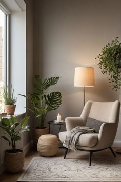 a living room with a chair, lamp and potted plants on the side table