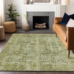 a living room filled with furniture and a green rug on the floor next to a fire place