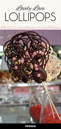 there is a chocolate cake with pink and white candies in it on a stick