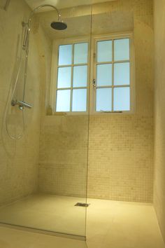 a bathroom with a shower and window in it